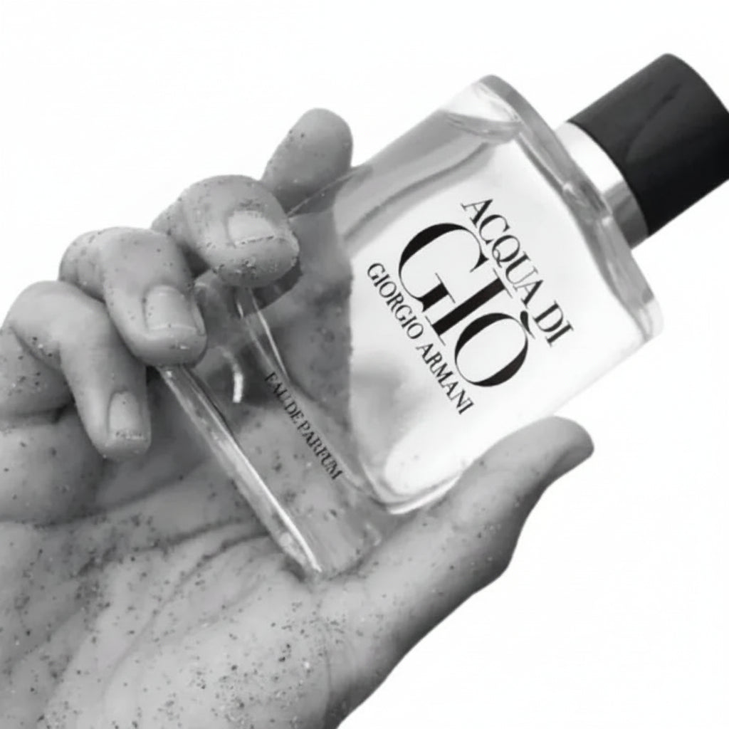 Hand holding a bottle of Acqua di Gio perfume by Giorgio Armani.